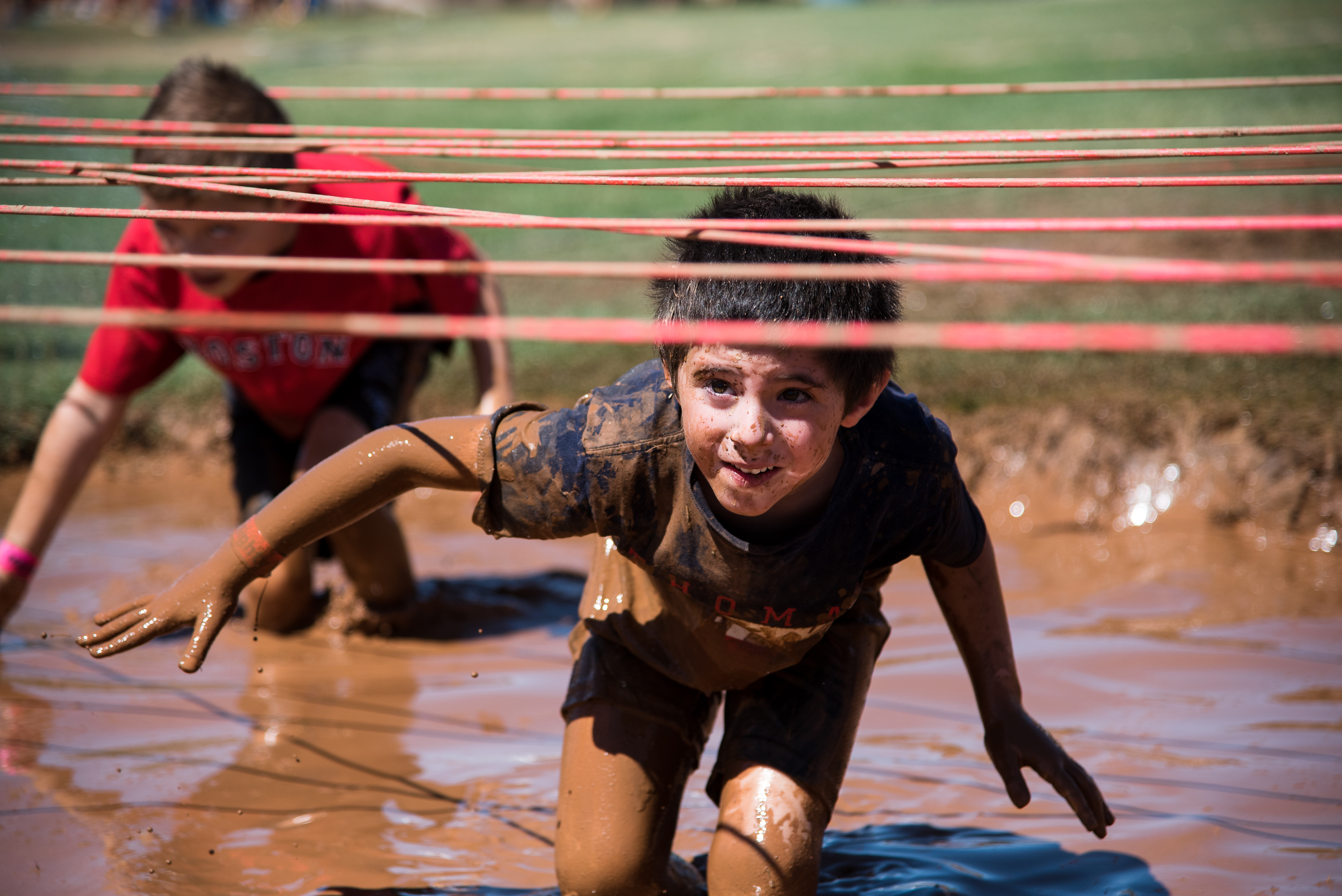 A child in a mud obstacle course